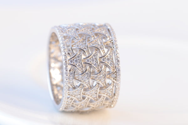 This elegant sterling silver band is nearly 14 mm wide, adding a subtle touch of sophistication to any look. This graceful ring will ensure you always make a stunning impression.